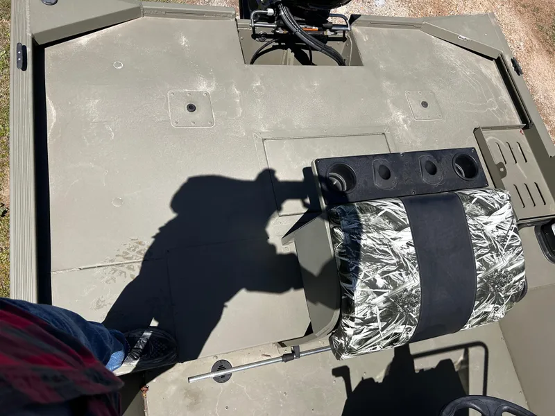 Slide: The Image of 2024 Tracker Grizzly 2072 CC Sportsman boat interior with camo seat and steering console. - 8