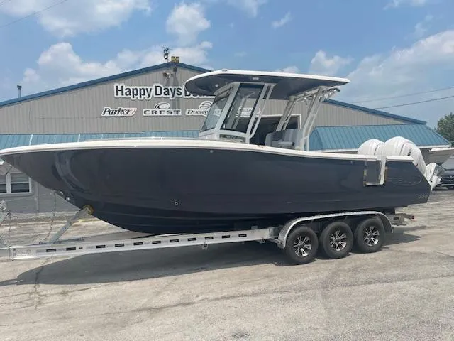 Slide: The Image of 2025 Robalo R270 Center Console boat on trailer at dealership. - 1