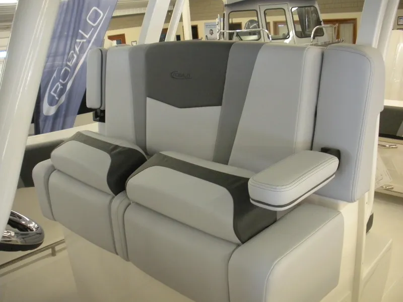 Slide: The Image of 2025 Robalo R270 Center Console boat seating, featuring modern gray and black upholstery. - 11