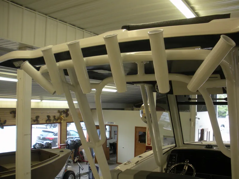 Slide: The Image of 2025 Robalo R270 Center Console boat with rod holders in showroom. - 13