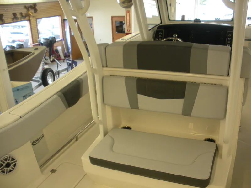 Slide: The Image of 2025 Robalo R270 Center Console boat interior with cushioned seating and modern design. - 14