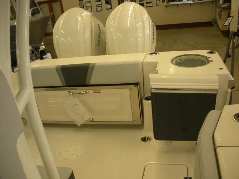 Slide: The Image of 2025 Robalo R270 Center Console boat interior with dual engines and seating area. - 15