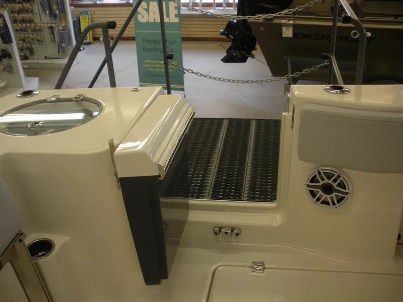 Slide: The Image of 2025 Robalo R270 Center Console boat interior with speaker and sale sign. - 17