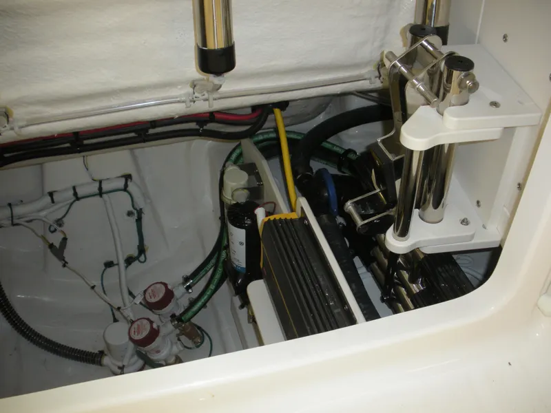 Slide: The Image of Engine compartment of 2025 Robalo R270 Center Console boat, showcasing mechanical components and wiring. - 18