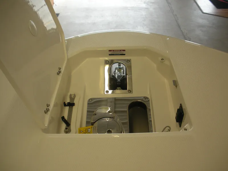 Slide: The Image of 2025 Robalo R270 Center Console anchor storage compartment, open lid, interior view. - 2