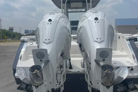 Slide: The Image of 2025 Robalo R270 Center Console with dual outboard engines, rear view. - 20