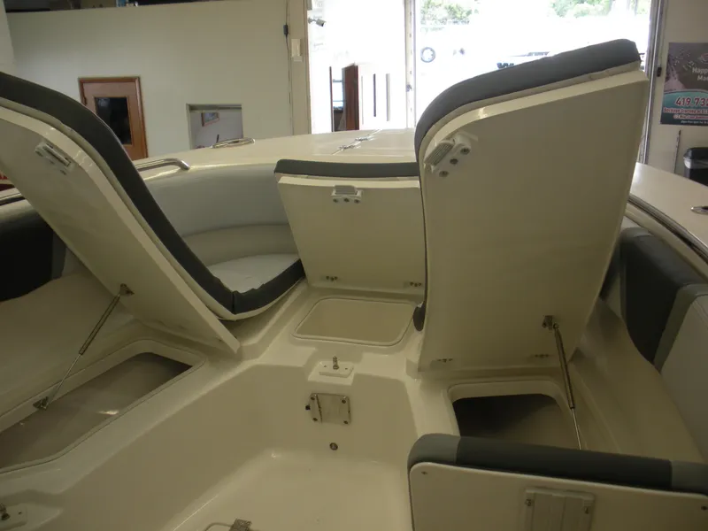 Slide: The Image of 2025 Robalo R270 Center Console boat interior with open storage compartments. - 4
