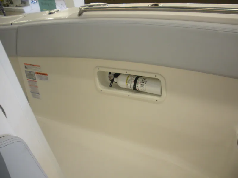 Slide: The Image of 2025 Robalo R270 Center Console boat interior with built-in fire extinguisher compartment. - 7