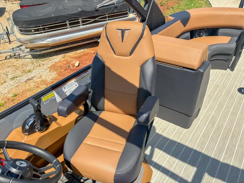 Slide: The Image of Captain's chair on 2025 Trifecta 25 RF SS pontoon boat, featuring tan and black upholstery. - 12