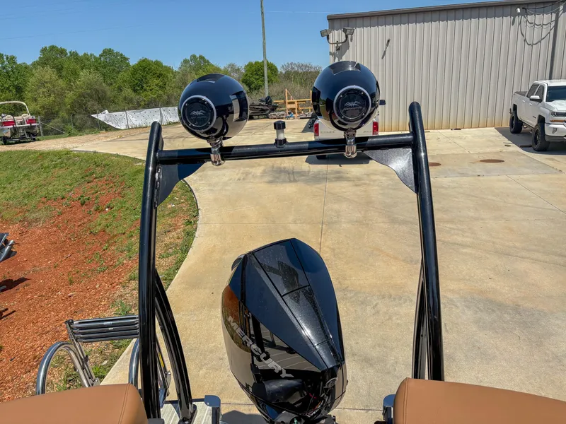 Slide: The Image of Rear view of 2025 Trifecta 25 RF SS boat with dual speakers and motor. - 16