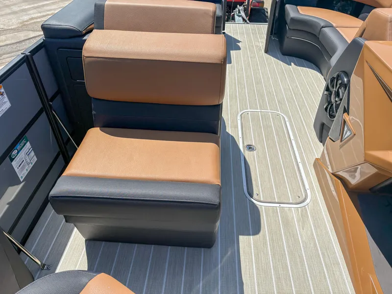 Slide: The Image of 2025 Trifecta 25 RF SS boat interior with brown and black seating on striped flooring. - 7