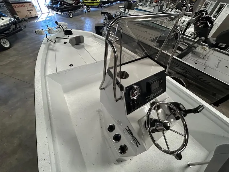 Slide: The Image of 2025 Xpress H 210 Bay boat interior with steering console in showroom. - 7