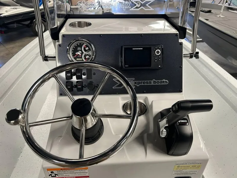 Slide: The Image of Steering console of 2025 Xpress H 210 Bay boat with controls and gauges. - 8