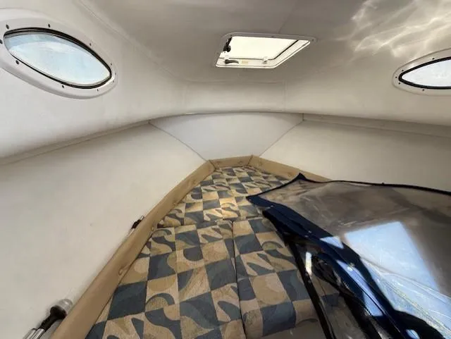 Slide: The Image of 2008 Pro-Line 20 Express cabin interior with patterned cushions and overhead hatch. - 13