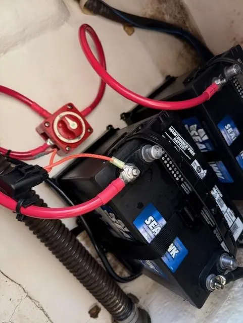 Slide: The Image of Boat battery setup in a 2008 Pro-Line 20 Express with red cables and connectors. - 15