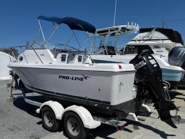 Slide: The Image of 2008 Pro-Line 20 Express boat on trailer with Suzuki outboard motor. - 2