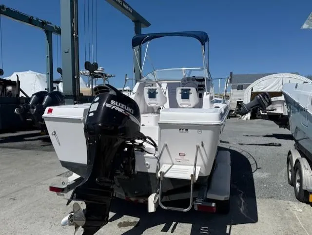 Slide: The Image of 2008 Pro-Line 20 Express boat with Suzuki outboard motor in a marina setting. - 4