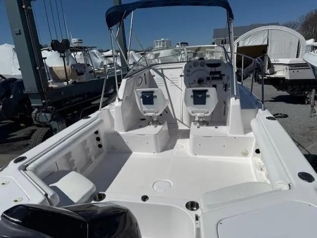 Slide: The Image of 2008 Pro-Line 20 Express boat with dual seats and canopy in a marina setting. - 7