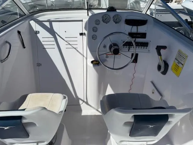 Slide: The Image of 2008 Pro-Line 20 Express boat cockpit with steering wheel and dual seats. - 9