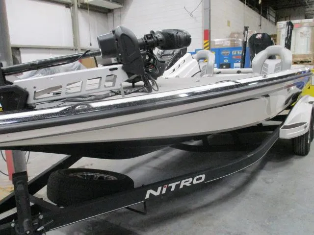 Slide: The Image of 2024 Nitro Z20 boat in warehouse, side view on trailer. - 0