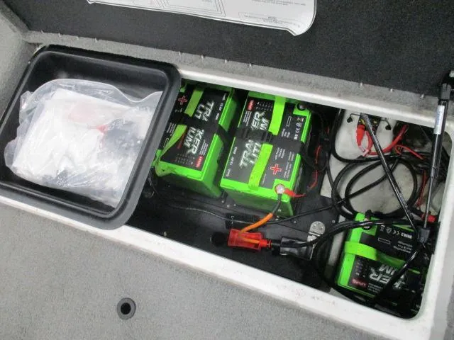 Slide: The Image of 2024 Nitro Z20 boat battery compartment with green batteries and wiring. - 11
