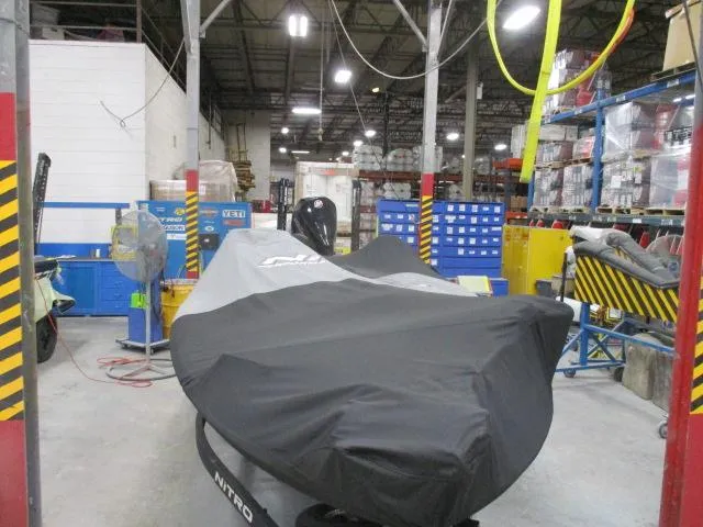 Slide: The Image of 2024 Nitro Z20 boat covered in a warehouse setting with industrial equipment. - 16