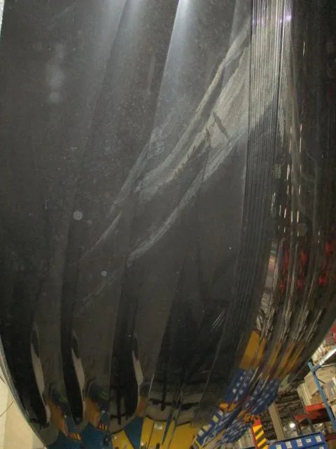 Slide: The Image of 2024 Nitro Z20 boat hull in a showroom, showcasing sleek black design and reflective surface. - 17