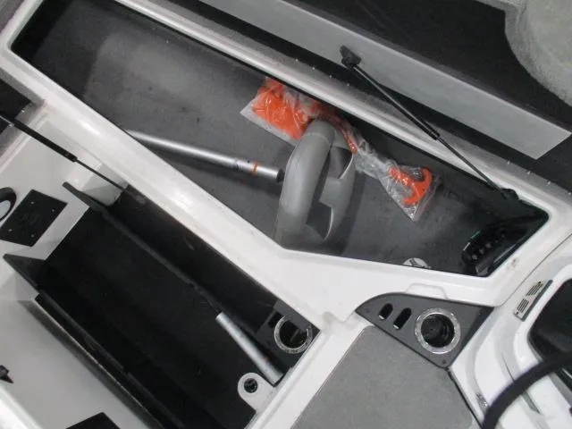 Slide: The Image of 2024 Nitro Z20 boat storage compartment with fishing rod and accessories. - 7
