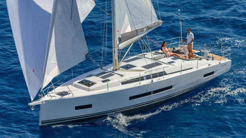 Slide: The Image of 2025 Hanse 410 yacht sailing on blue ocean with two people on deck. - 10