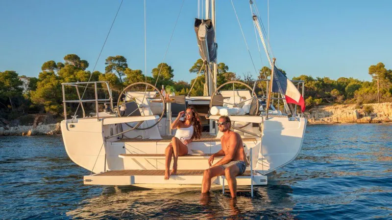 Slide: The Image of Couple relaxing on a 2025 Hanse 410 sailboat in sunny coastal waters. - 4