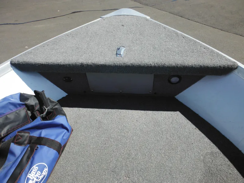 Slide: The Image of 2006 Alumacraft Lunker 165 LTD CS boat interior with carpeted deck and storage compartment. - 14