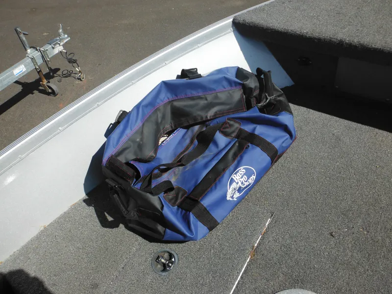 Slide: The Image of Blue duffel bag on 2006 Alumacraft Lunker 165 LTD CS boat deck. - 15