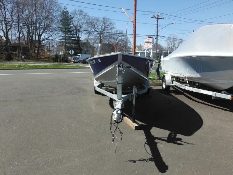 Slide: The Image of 2006 Alumacraft Lunker 165 LTD CS boat on trailer in parking lot. - 2