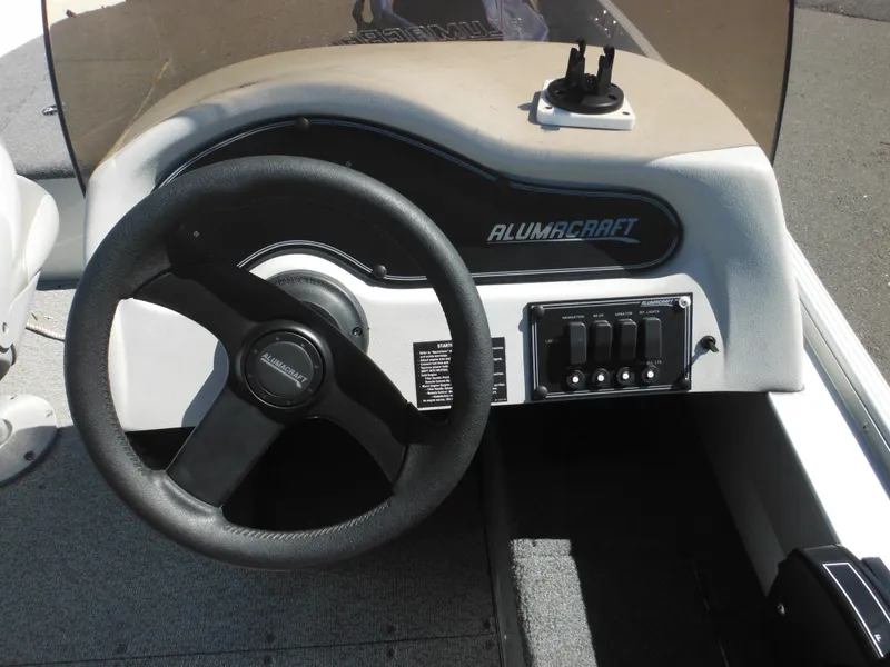 Slide: The Image of 2006 Alumacraft Lunker 165 LTD CS boat dashboard with steering wheel and control panel. - 24