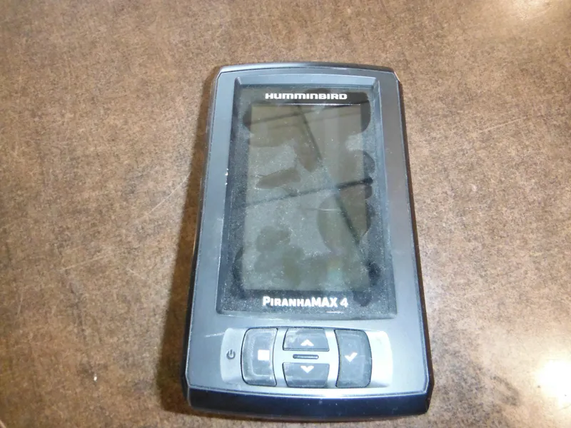 Slide: The Image of Humminbird PiranhaMax 4 fish finder on a brown surface. - 26