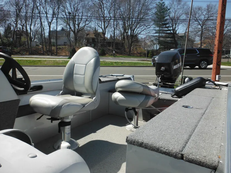 Slide: The Image of 2006 Alumacraft Lunker 165 LTD CS boat interior with seating and Mercury outboard motor. - 7