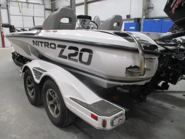 Slide: The Image of 2024 Nitro Z20 boat on trailer in garage setting. - 0