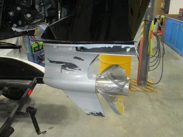 Slide: The Image of 2024 Nitro Z20 boat motor with visible wear and scratches in a workshop setting. - 10