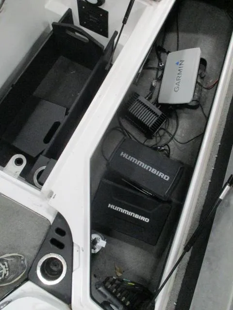 Slide: The Image of 2024 Nitro Z20 boat electronics compartment with Humminbird and Garmin devices. - 13