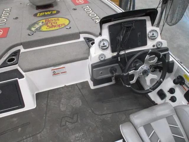 Slide: The Image of 2024 Nitro Z20 boat cockpit with steering wheel, dashboard, and branded carpet. - 17