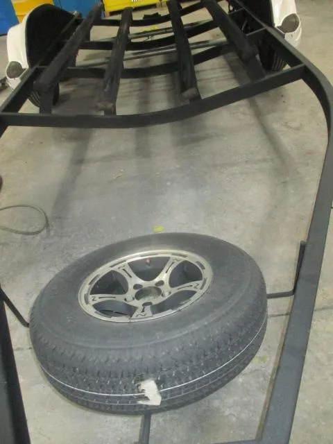 Slide: The Image of 2024 Nitro Z20 trailer frame with spare tire on concrete floor. - 20