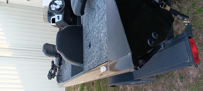 Slide: The Image of 2025 Tracker Pro Team 190 boat on trailer, featuring seating and control panel. - 11