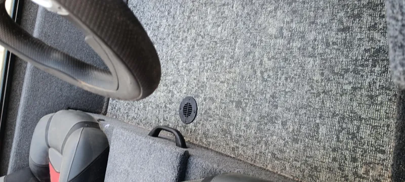 Slide: The Image of Interior view of 2025 Tracker Pro Team 190 boat with carpeted flooring and steering wheel. - 3