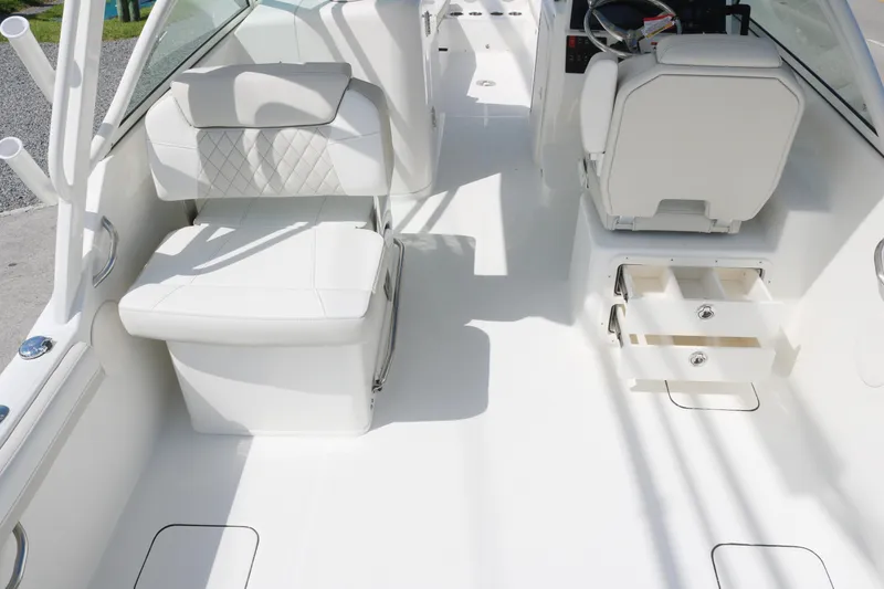 Slide: The Image of 2025 World Cat 230 DC interior with white seating and storage compartments. - 10