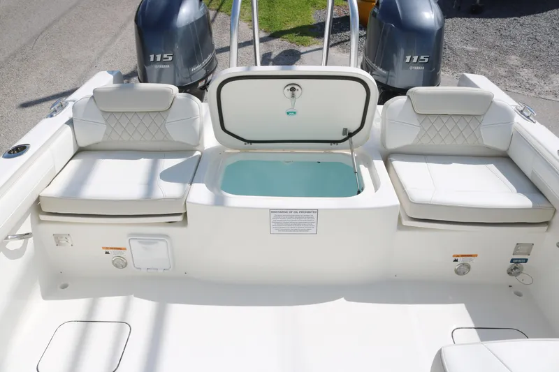 Slide: The Image of 2025 World Cat 230 DC boat interior with seating and storage compartments. - 11