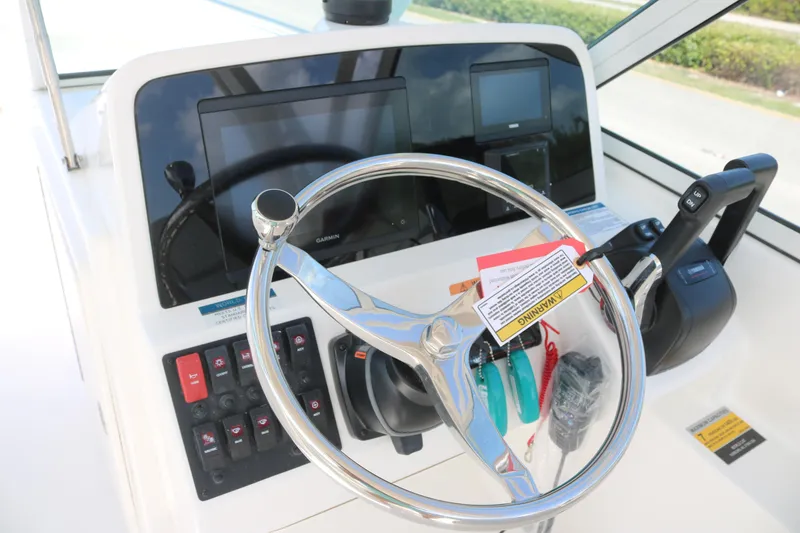 Slide: The Image of Steering console of 2025 World Cat 230 DC boat with modern controls and displays. - 3