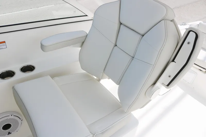 Slide: The Image of Luxurious white seat on 2025 World Cat 230 DC boat, featuring armrest and cup holders. - 4
