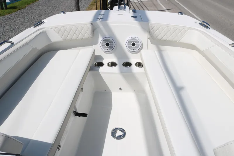 Slide: The Image of 2025 World Cat 230 DC boat interior with white seating and cup holders. - 5