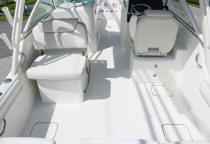 Slide: The Image of Interior of 2025 World Cat 230 DC boat, featuring white seating and sleek design. - 9