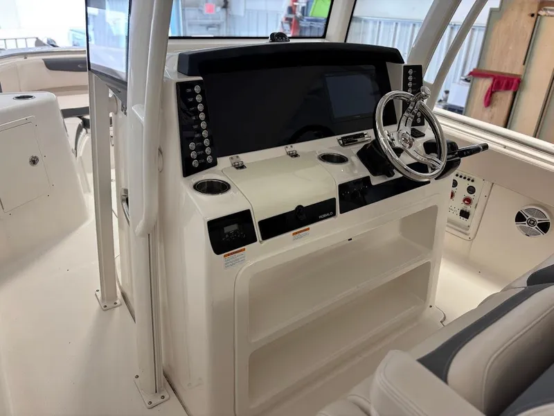 Slide: The Image of 2017 Robalo R302 Center Console boat dashboard with steering wheel and controls. - 10